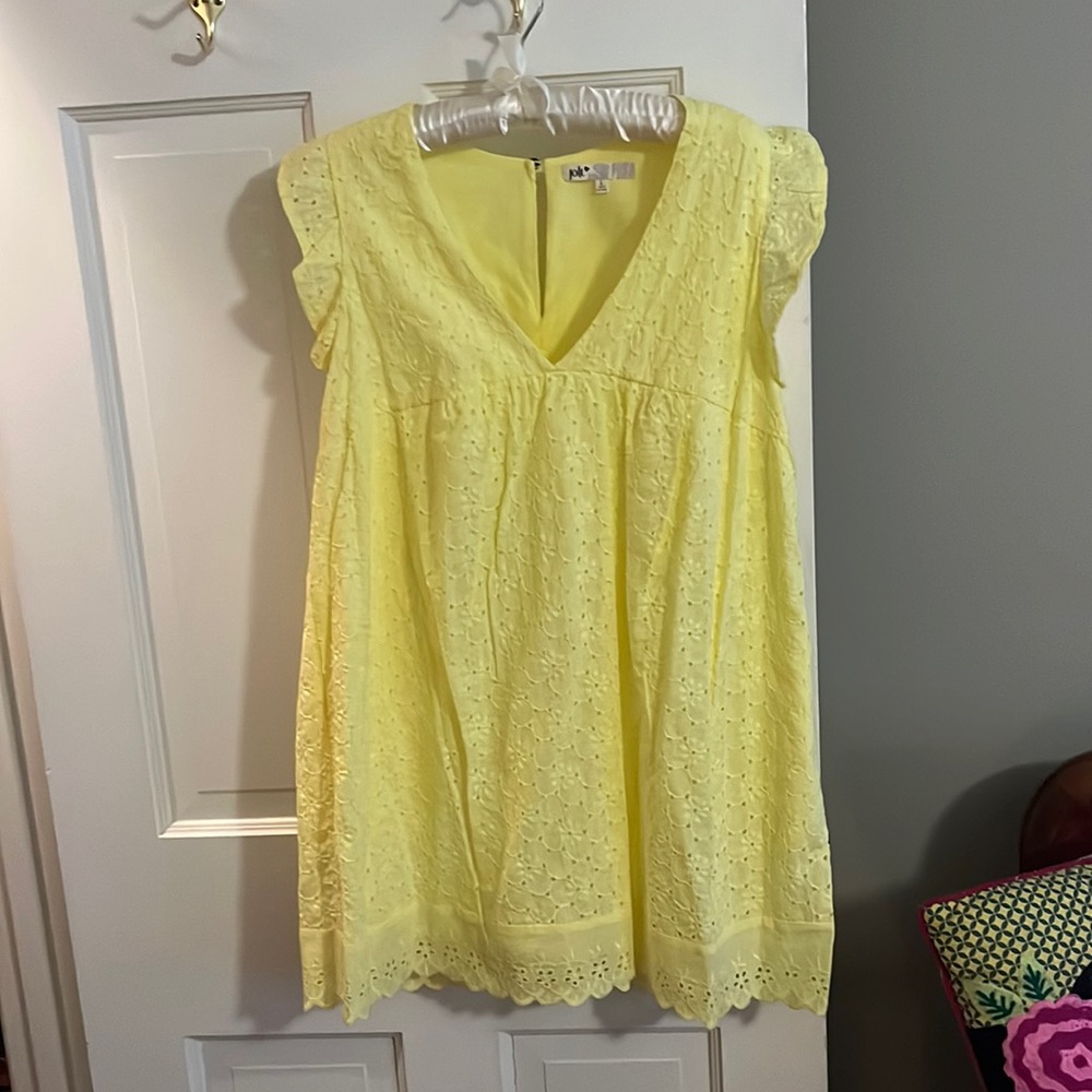 Yellow eyelet mini dress with pockets and shorts underneath and it’s lined.